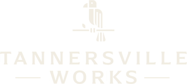 Logo for Tannersville Works with a stylized pencil icon on a white background