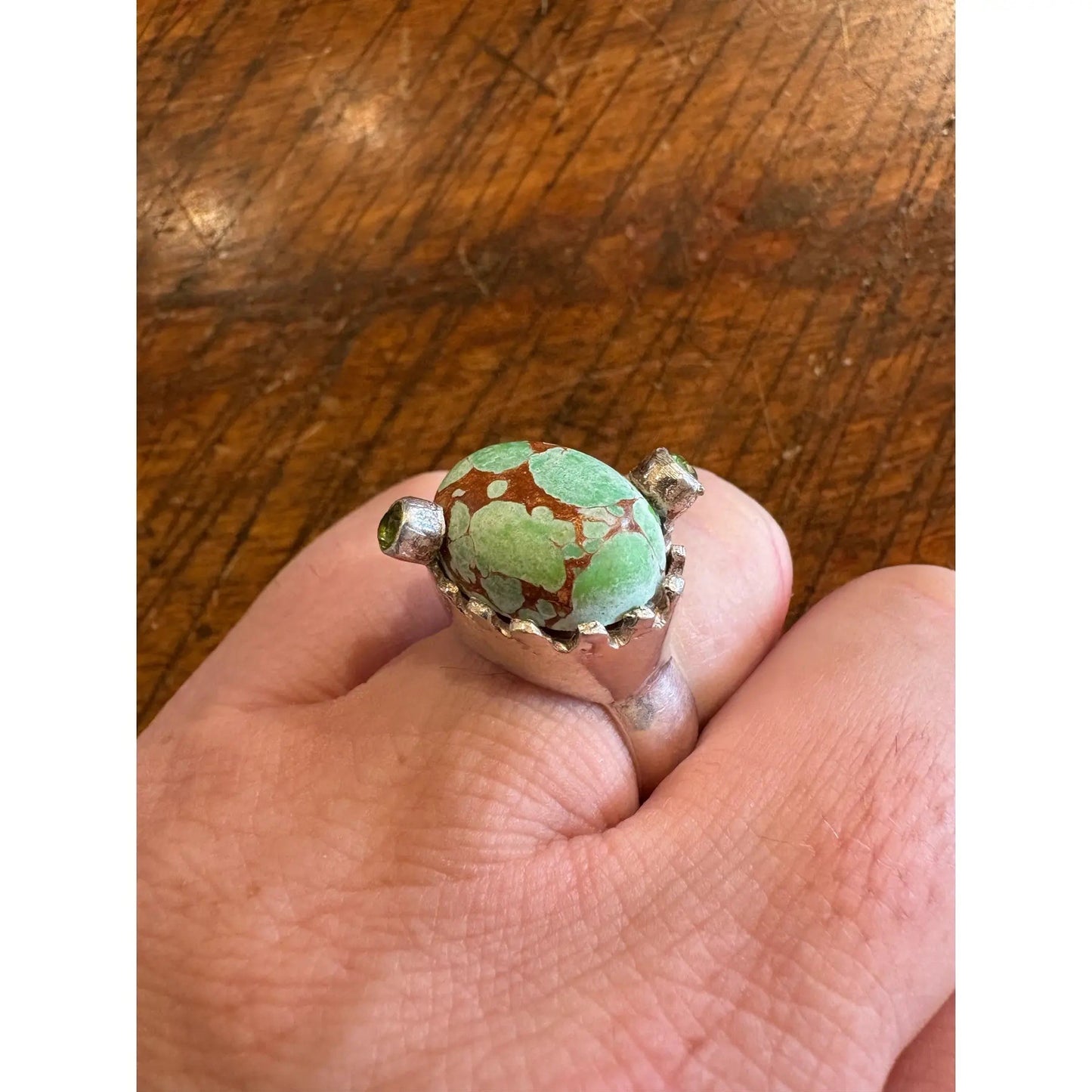 Turquoise Ring in a Crown Shaped Sterling Silver Setting With Two Peridot Gemstones