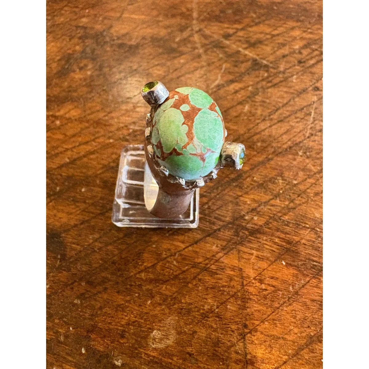Turquoise Ring in a Crown Shaped Sterling Silver Setting With Two Peridot Gemstones