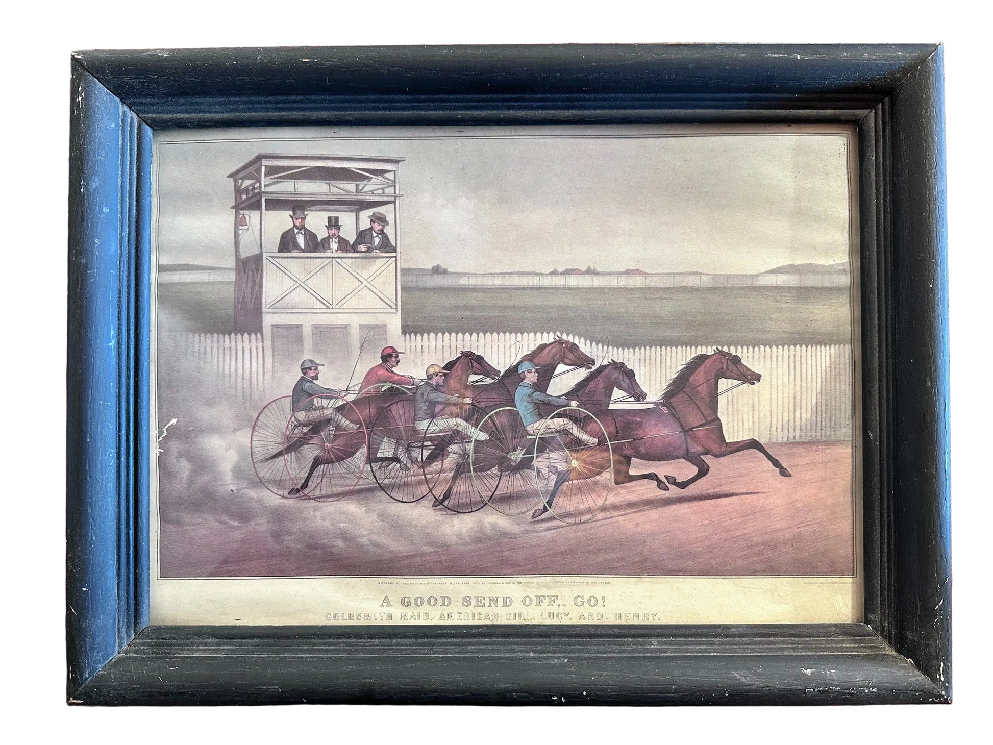 Framed print of a horse race scene with horses and riders on a track.