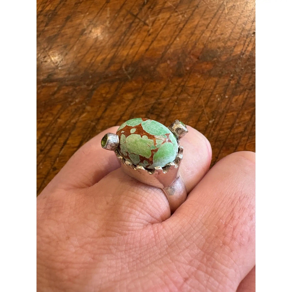 Turquoise Ring in a Crown Shaped Sterling Silver Setting With Two Peridot Gemstones